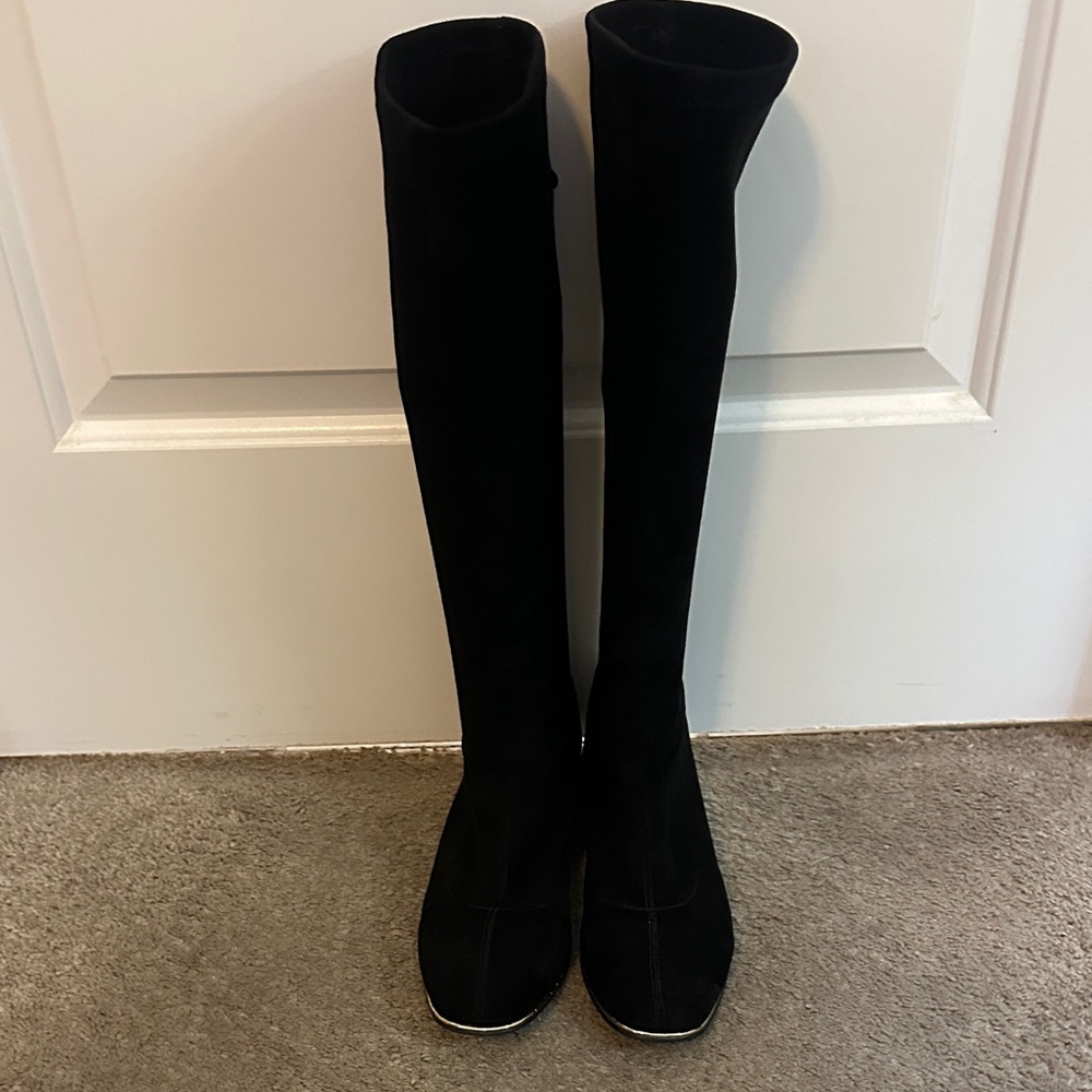 C. Paravano knee high black suede boots with gold heal.